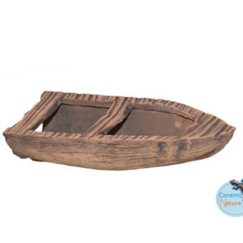 Dekorativt akvarietilbehør i form af en keramisk båd til akvaskaping tilføjer naturlig charme til enhver undervandsverden.