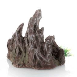 Akvariedekoration i brun farve med ujævne klipper og grønne detaljer.